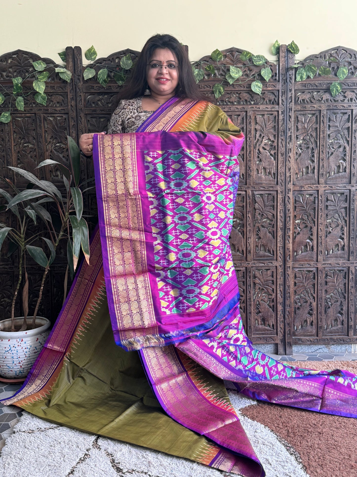 Ikkat Pattu Saree Olive Green colored complemented with a Kanchi border. - Sampradaya Designer Studio