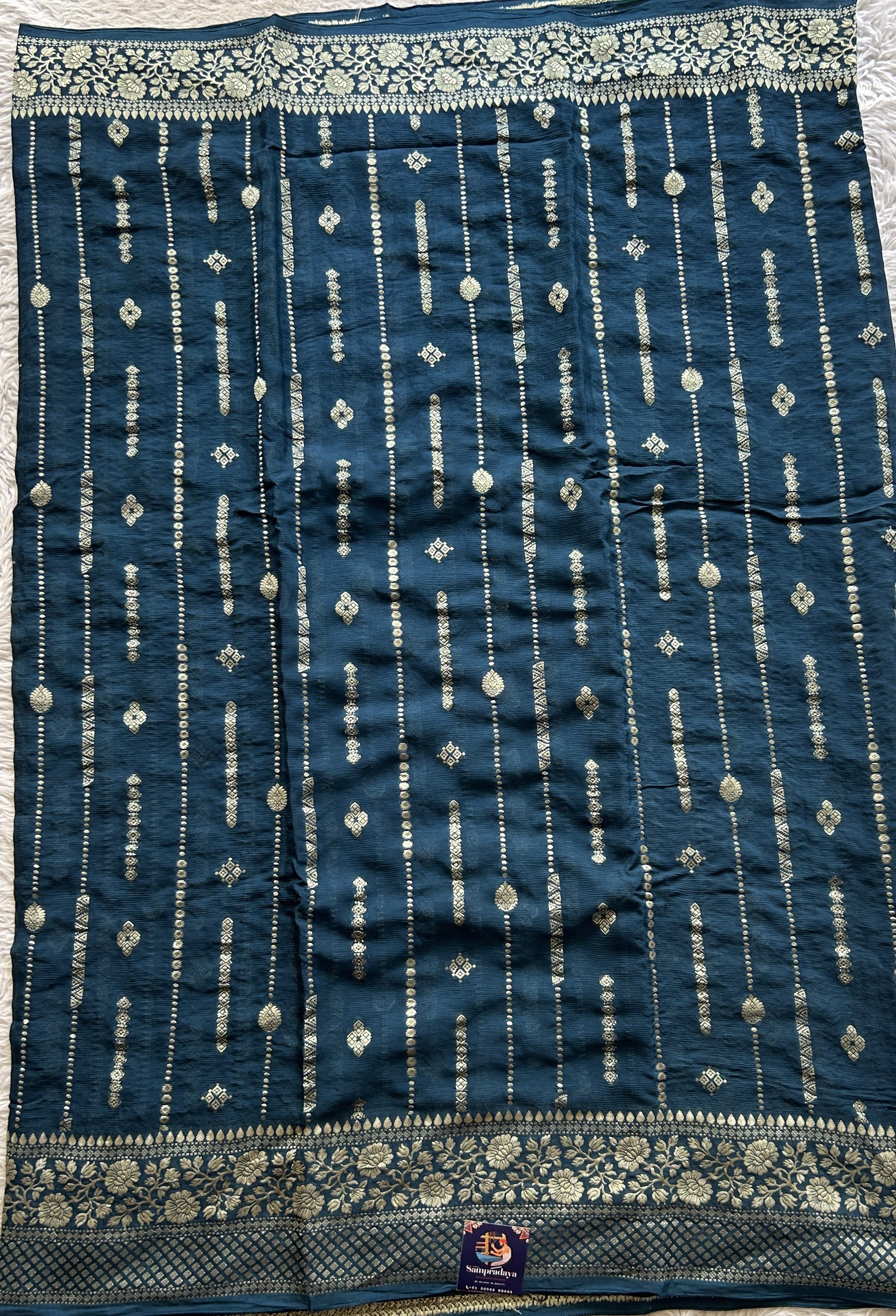 Semi Georgette Saree Peacock Blue Colored Paired with a Zari Border. - Sampradaya Designer Studio