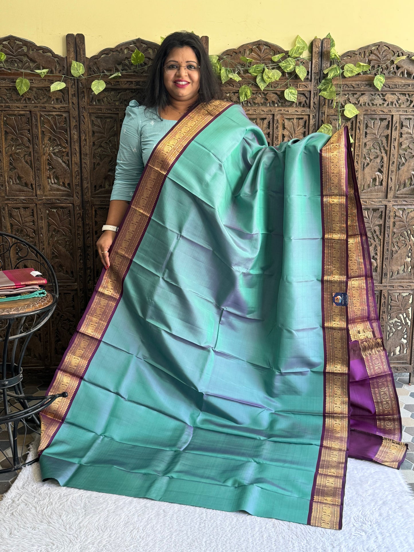 Pure Kanjivaram Silk Saree Light Teal Blue Colored Elegantly Paid with a Gold Zari Border.