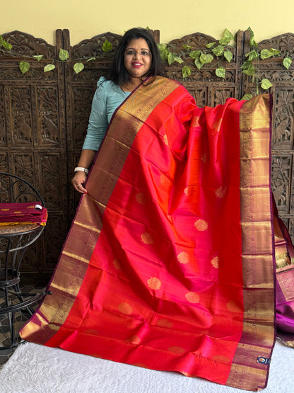 Pure Kanjivaram Silk Saree Cerise Colored Elegantly Paid with a Gold Zari Border.