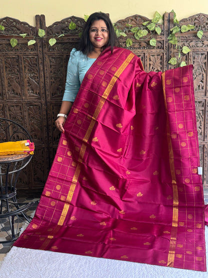 Pure Kanjivaram Silk Saree Light Wain Colored Elegantly Paid with a Gold Zari Border.