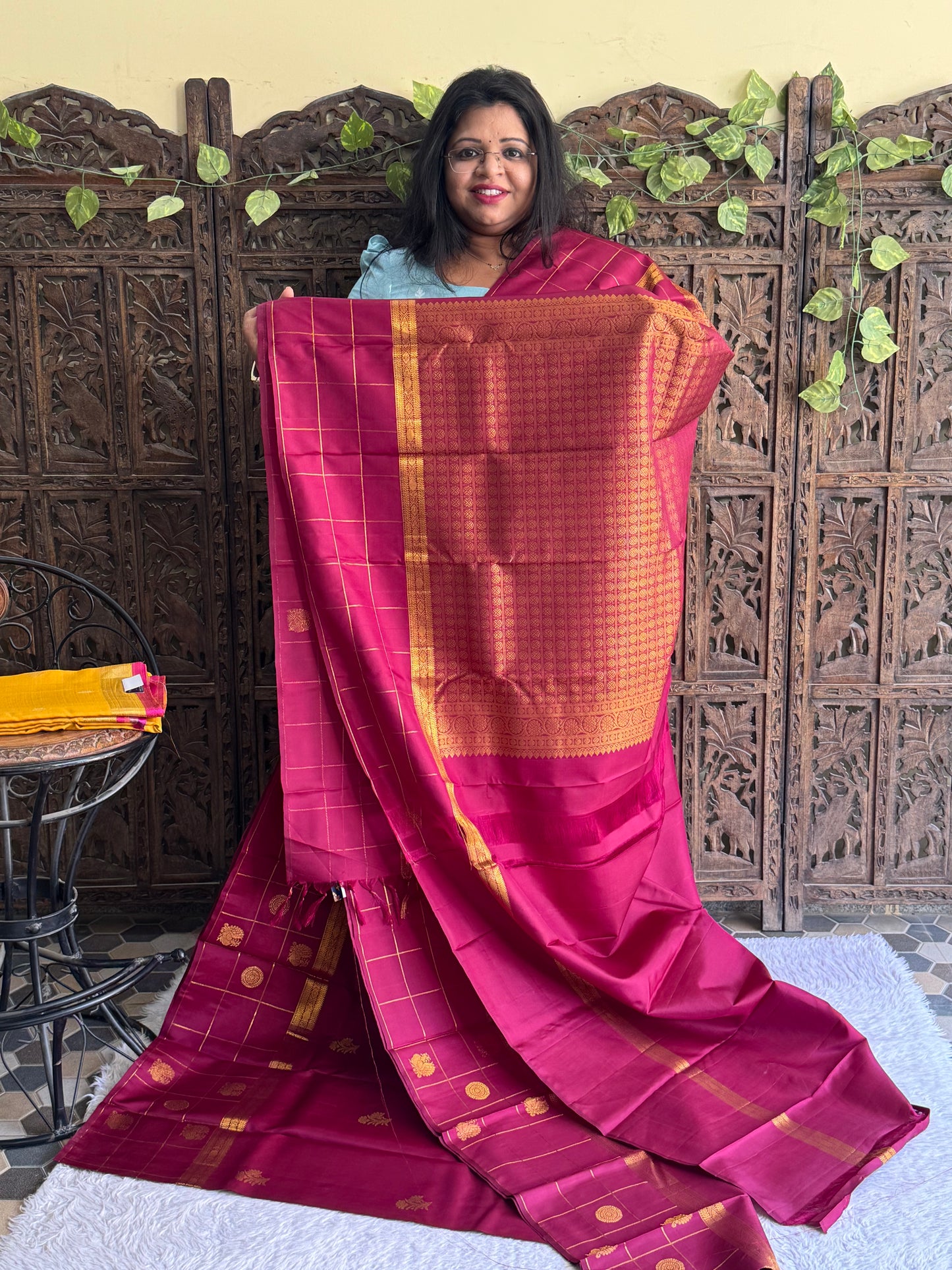 Pure Kanjivaram Silk Saree Light Wain Colored Elegantly Paid with a Gold Zari Border.