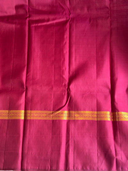 Pure Kanjivaram Silk Saree Light Wain Colored Elegantly Paid with a Gold Zari Border.