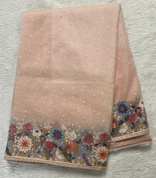 Soft Organza Designer Saree Coral colored Saree complemented with a Machine Embroidery border. - Sampradaya Designer Studio