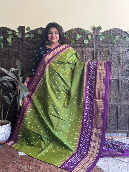 Ikkat Pattu Saree Olive Green colored complemented with a Purple Kanchi border. - Sampradaya Designer Studio