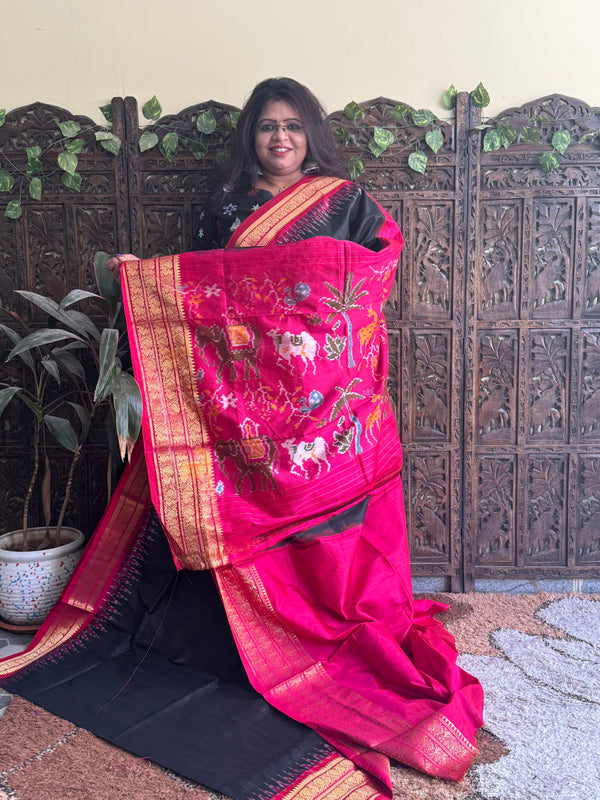 Ikkat Pattu Saree Black colored complemented with a Pink Kanchi border. - Sampradaya Designer Studio