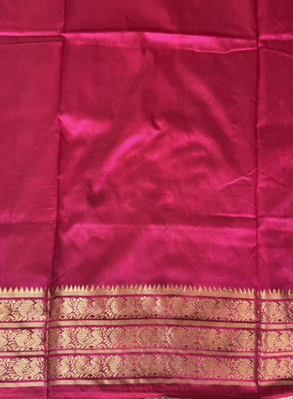 Ikkat Pattu Saree Black colored complemented with a Pink Kanchi border. - Sampradaya Designer Studio