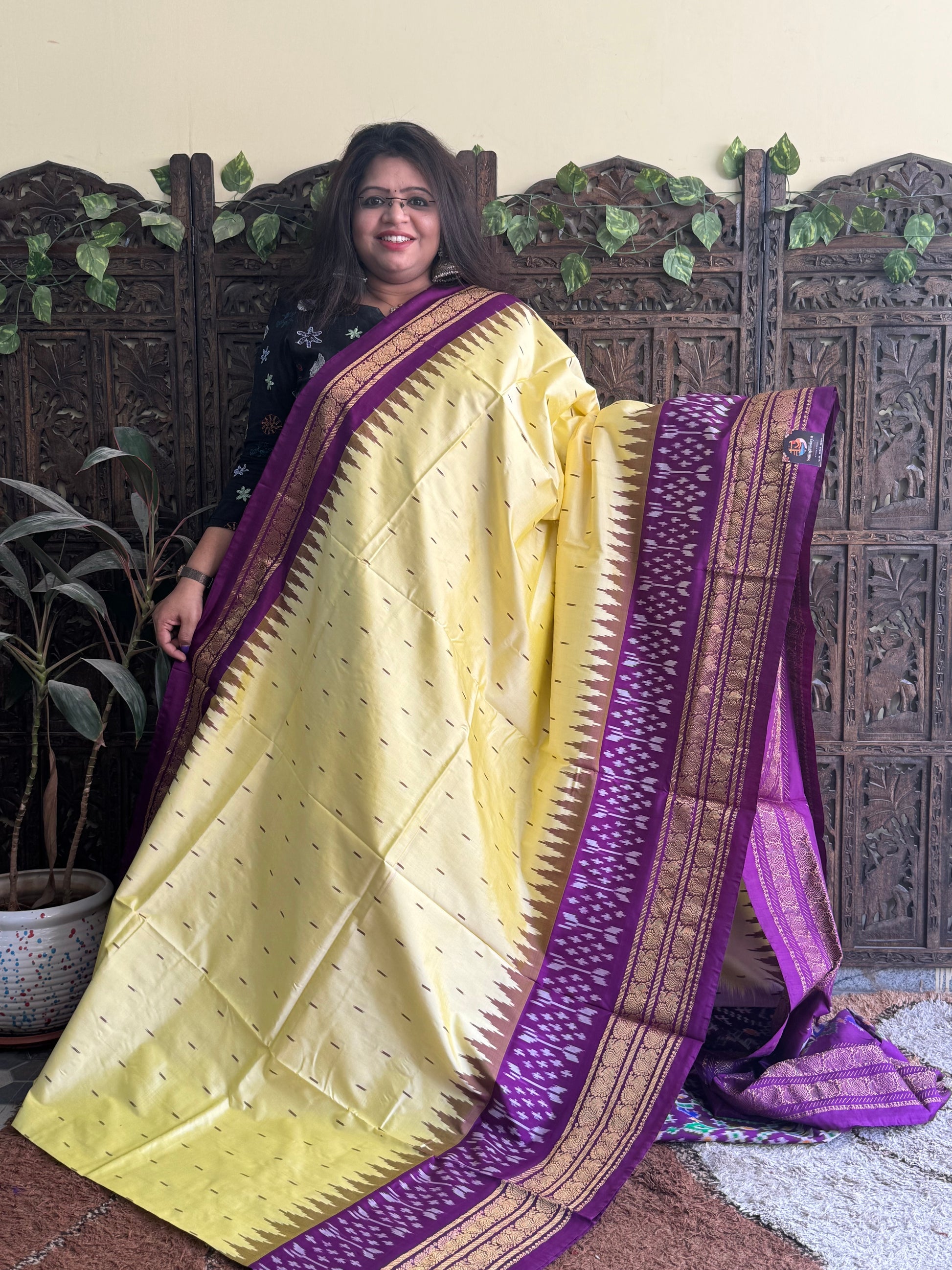 Ikkat Pattu Saree Cream colored complemented with a Purple Kanchi border. - Sampradaya Designer Studio