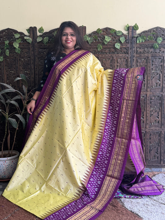 Ikkat Pattu Saree Cream colored complemented with a Purple Kanchi border. - Sampradaya Designer Studio