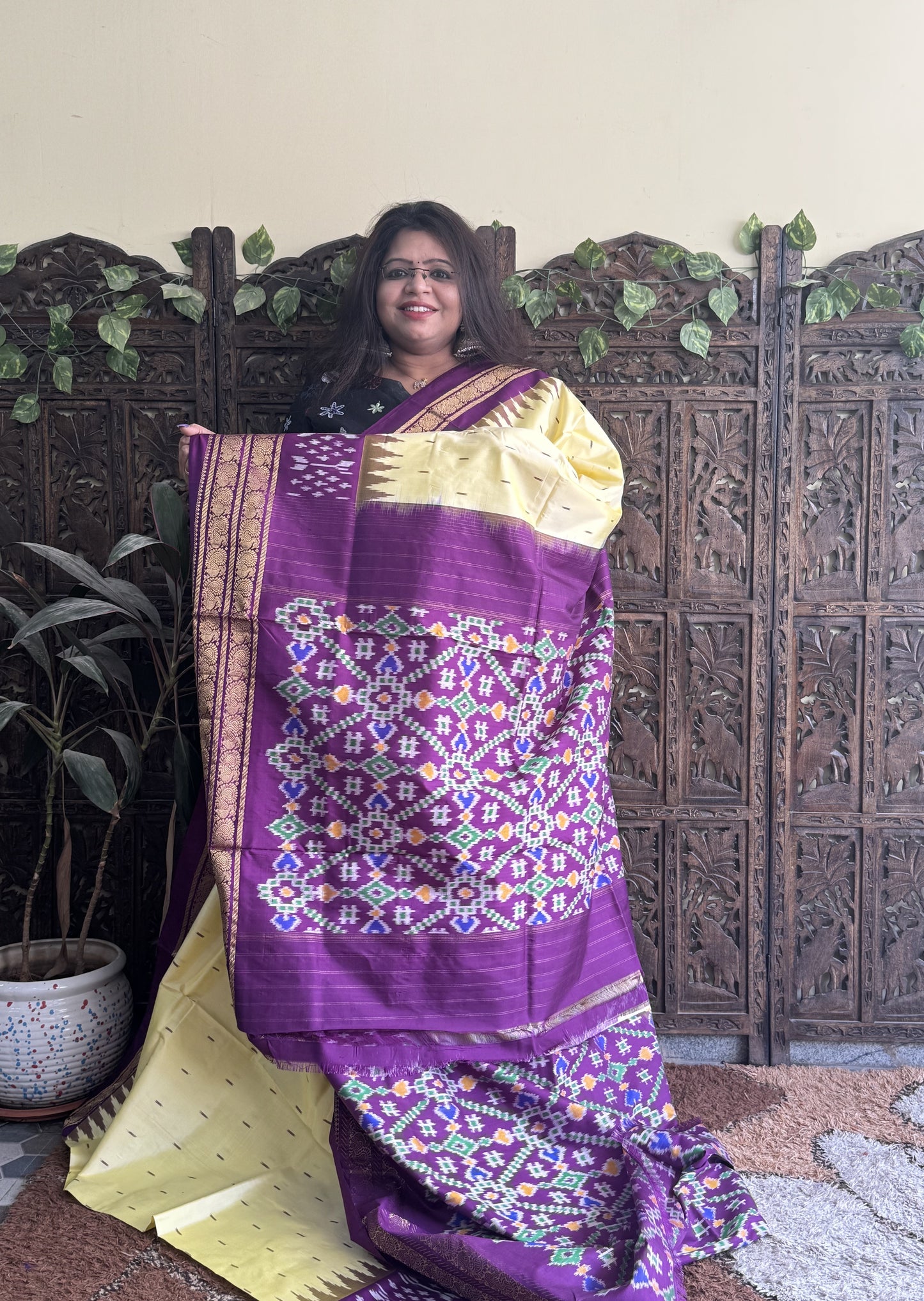 Ikkat Pattu Saree Cream colored complemented with a Purple Kanchi border. - Sampradaya Designer Studio