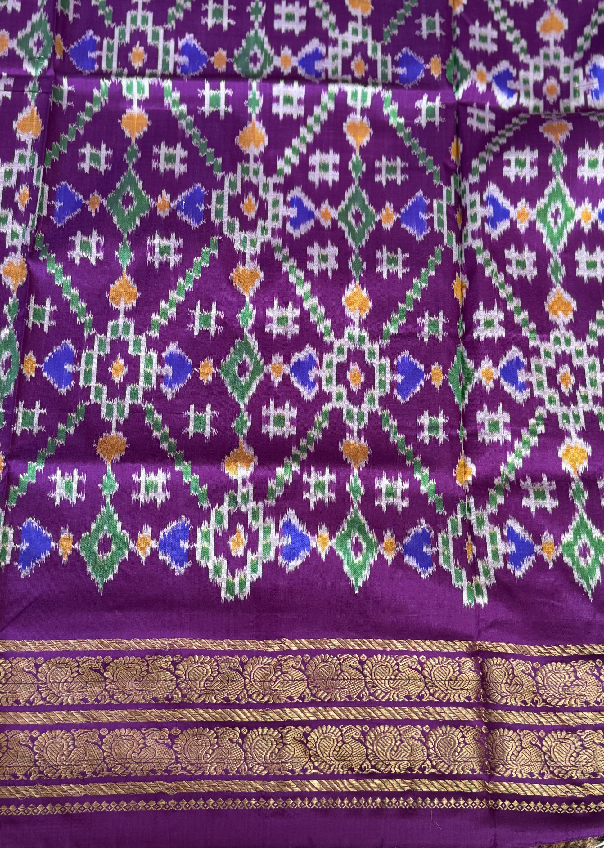 Ikkat Pattu Saree Cream colored complemented with a Purple Kanchi border. - Sampradaya Designer Studio