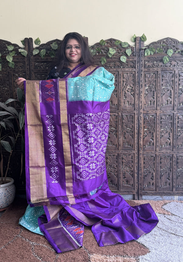 Ikkat Pattu Saree Sea Green colored complemented with a Violet Kanchi border. - Sampradaya Designer Studio