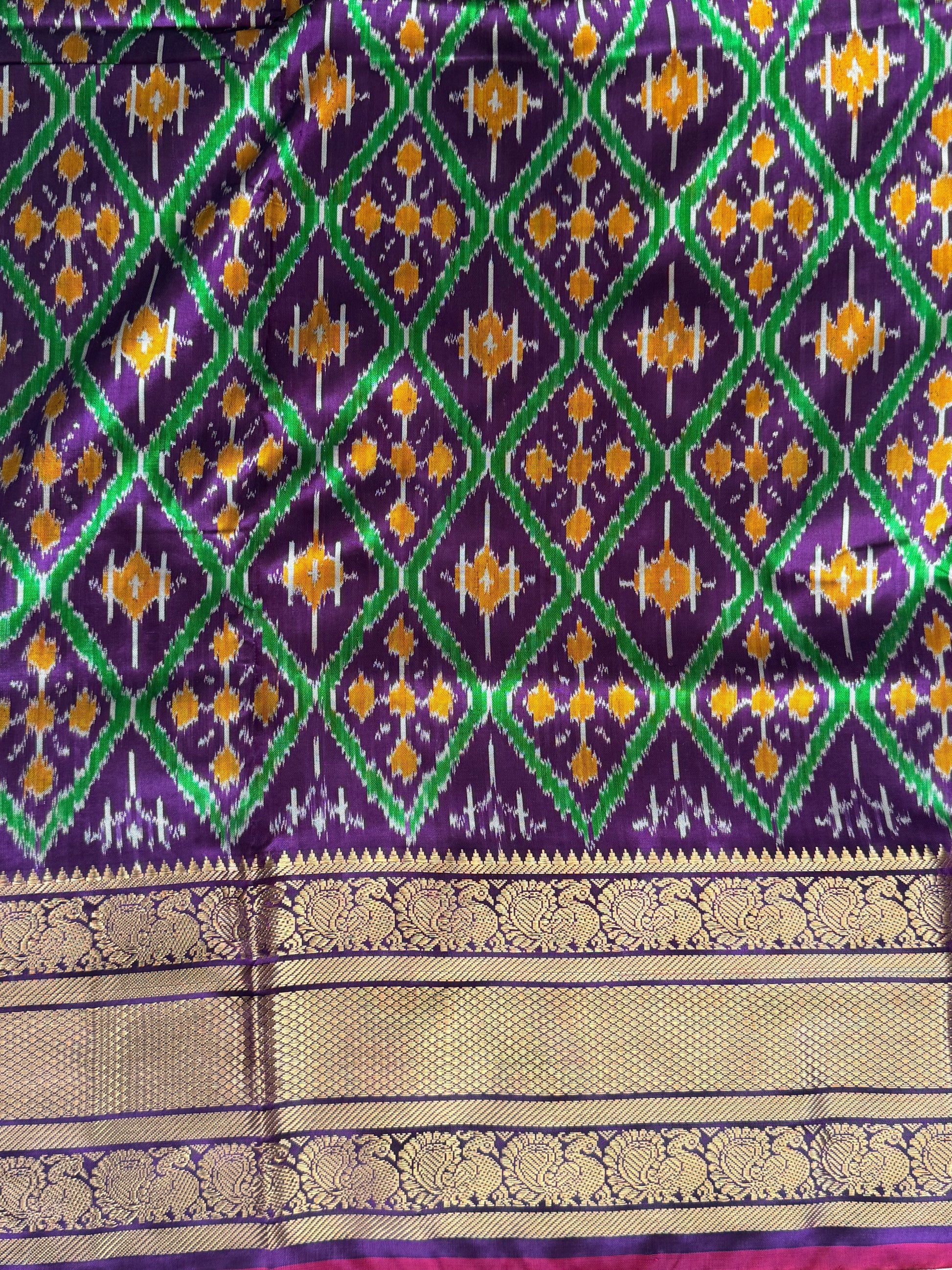 Ikkat Pattu Saree Violet colored complemented with a Kanchi border. - Sampradaya Designer Studio