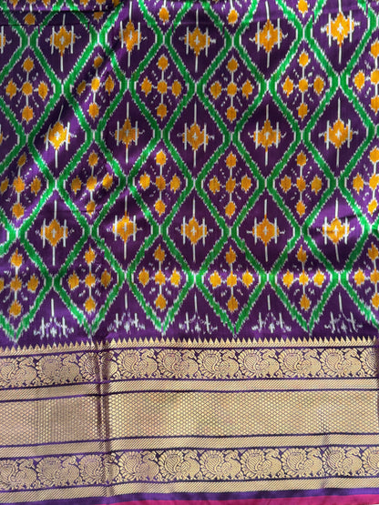 Ikkat Pattu Saree Violet colored complemented with a Kanchi border. - Sampradaya Designer Studio