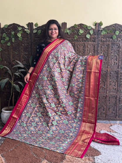 Ikkat Pattu Saree Gray colored complemented with a Dark PinkKanchi border. - Sampradaya Designer Studio
