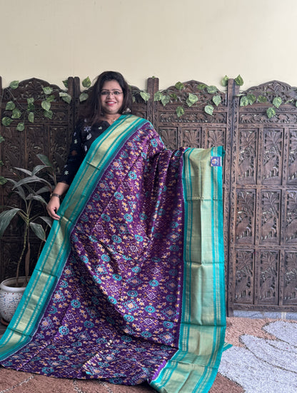 Ikkat Pattu Saree Purple colored complemented with a Sea Green Kanchi border. - Sampradaya Designer Studio