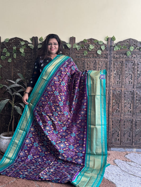 Ikkat Pattu Saree Purple colored complemented with a Sea Green Kanchi border. - Sampradaya Designer Studio
