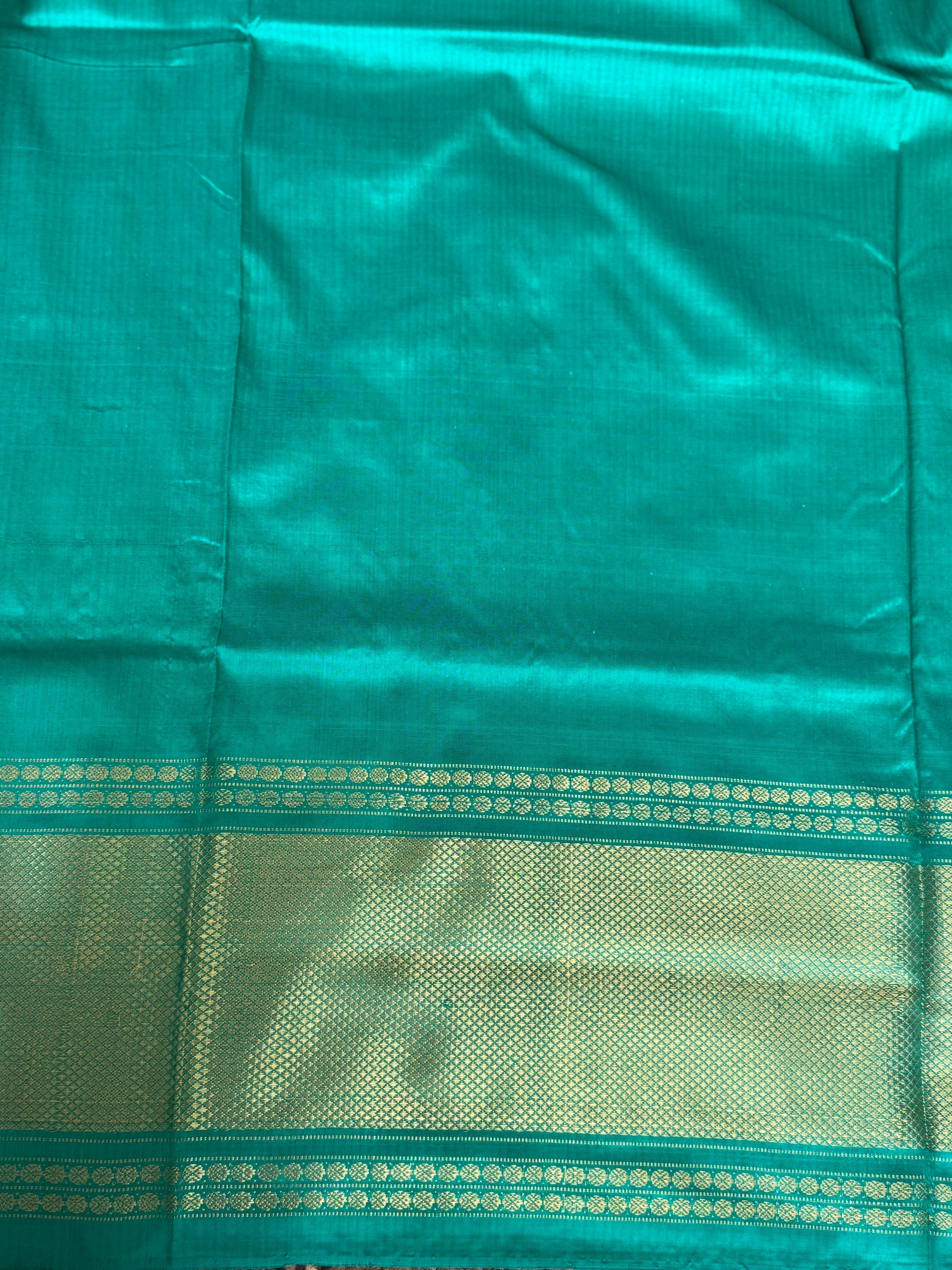 Ikkat Pattu Saree Purple colored complemented with a Sea Green Kanchi border. - Sampradaya Designer Studio