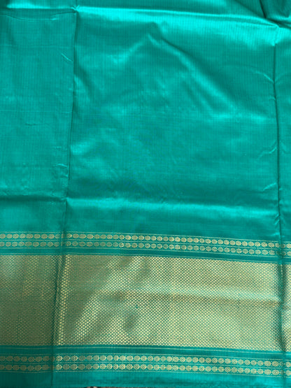 Ikkat Pattu Saree Purple colored complemented with a Sea Green Kanchi border. - Sampradaya Designer Studio