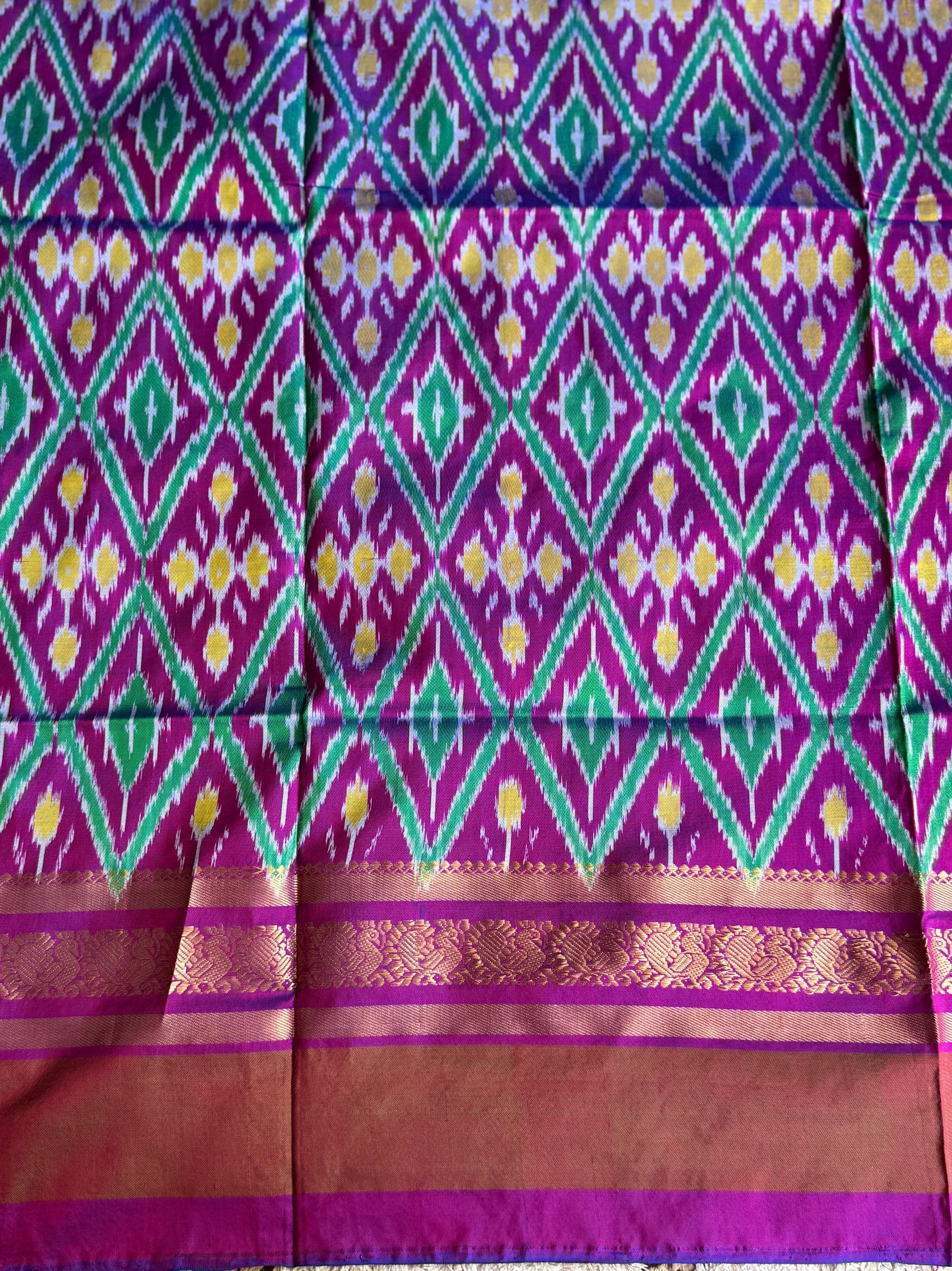 Ikkat Pattu Saree Dark Maroon colored complemented with a Kanchi border. - Sampradaya Designer Studio