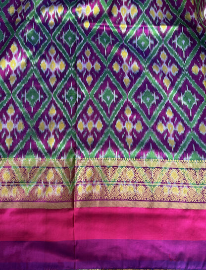 Ikkat Pattu Saree Sea foam colored complemented with a Kanchi border. - Sampradaya Designer Studio