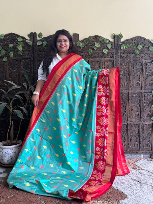 Ikkat Pattu Saree Sea Green colored complemented with a Zari border. - Sampradaya Designer Studio