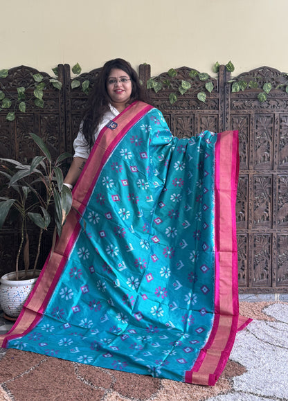 Ikkat Pattu Saree Turquoise colored complemented with a Zari border. - Sampradaya Designer Studio