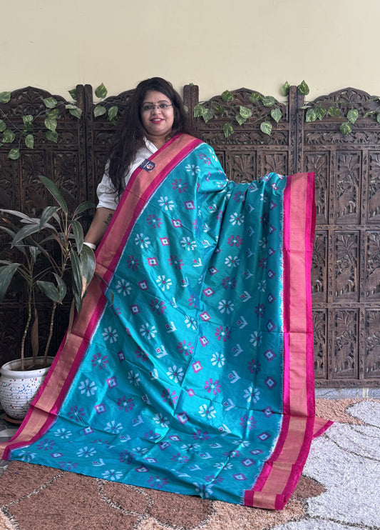 Ikkat Pattu Saree Turquoise colored complemented with a Zari border. - Sampradaya Designer Studio