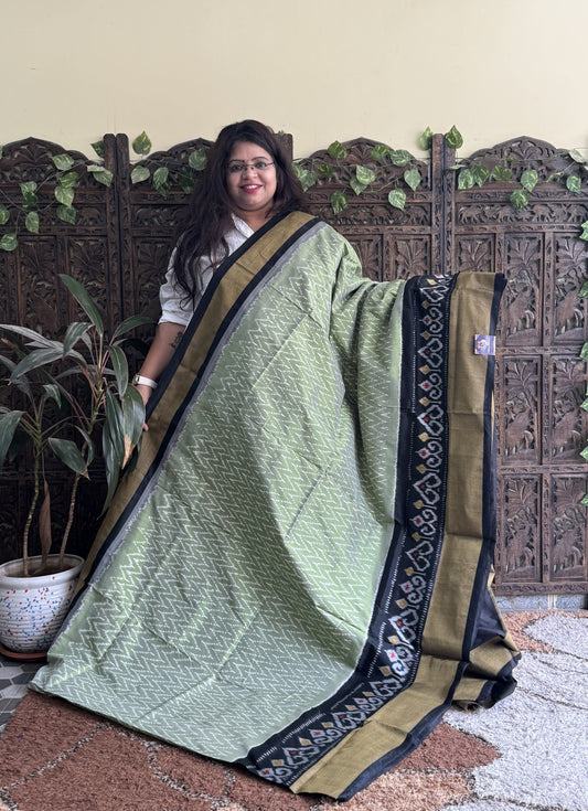 Ikkat Pattu Saree Olive Green colored complemented with a Ikkat Zari border. - Sampradaya Designer Studio