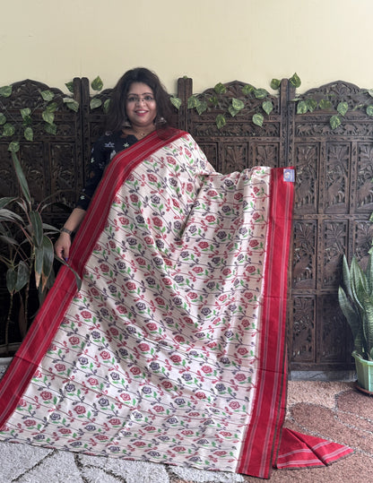 Ikkat Pattu Saree Cream colored complemented with a Patola border. - Sampradaya Designer Studio