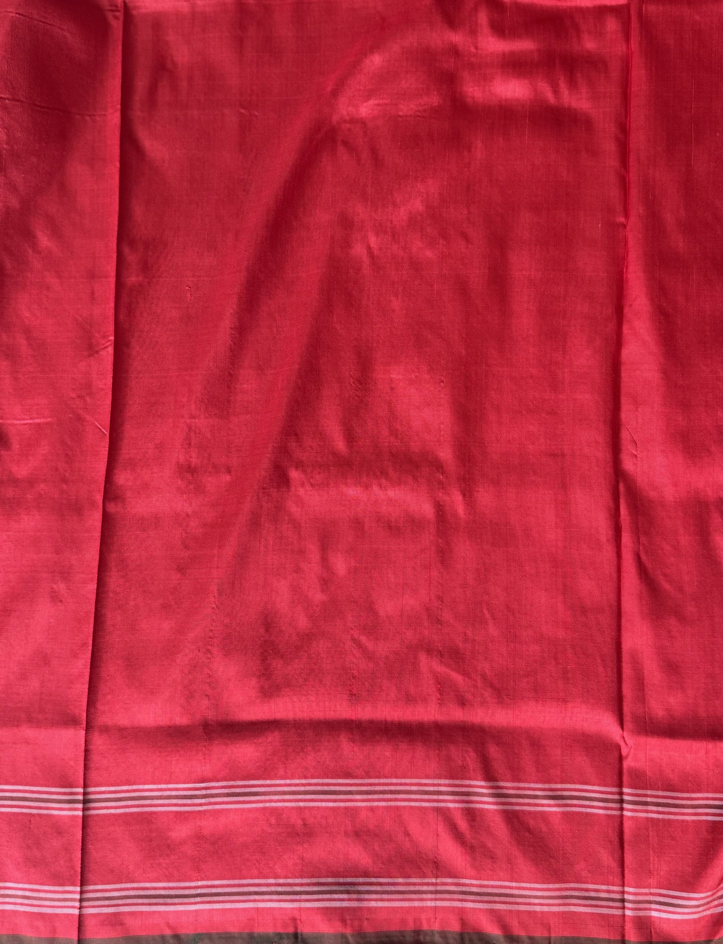 Ikkat Pattu Saree Cream colored complemented with a Patola border. - Sampradaya Designer Studio