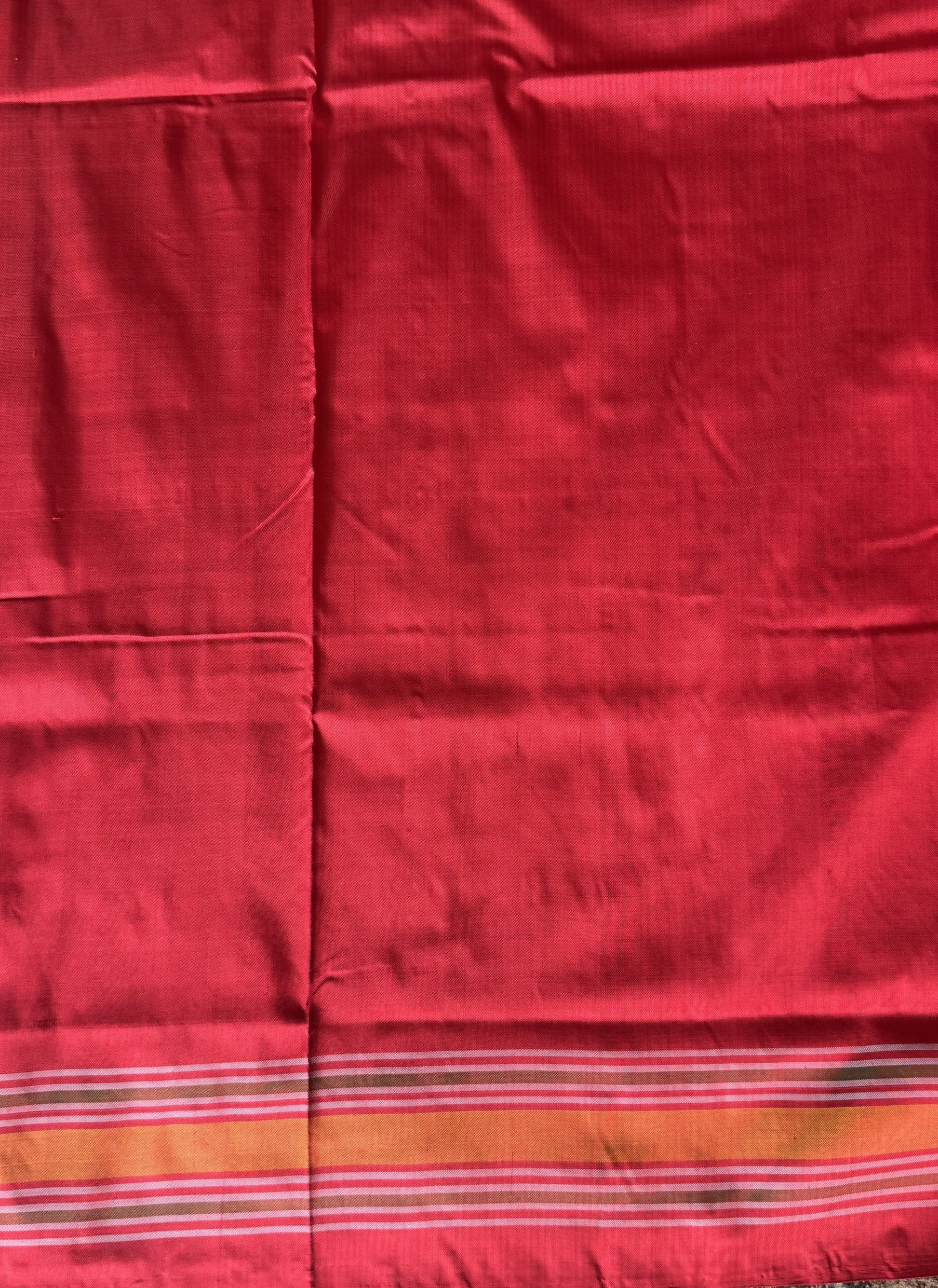 Ikkat Pattu Saree Cream colored complemented with a Red Patola border. - Sampradaya Designer Studio