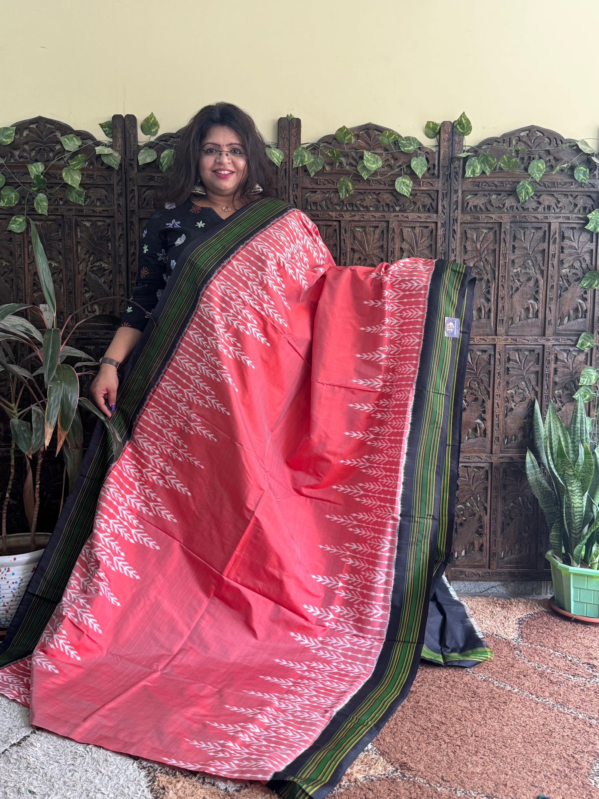 Ikkat Pattu Saree Peach colored complemented with a Patola border. - Sampradaya Designer Studio