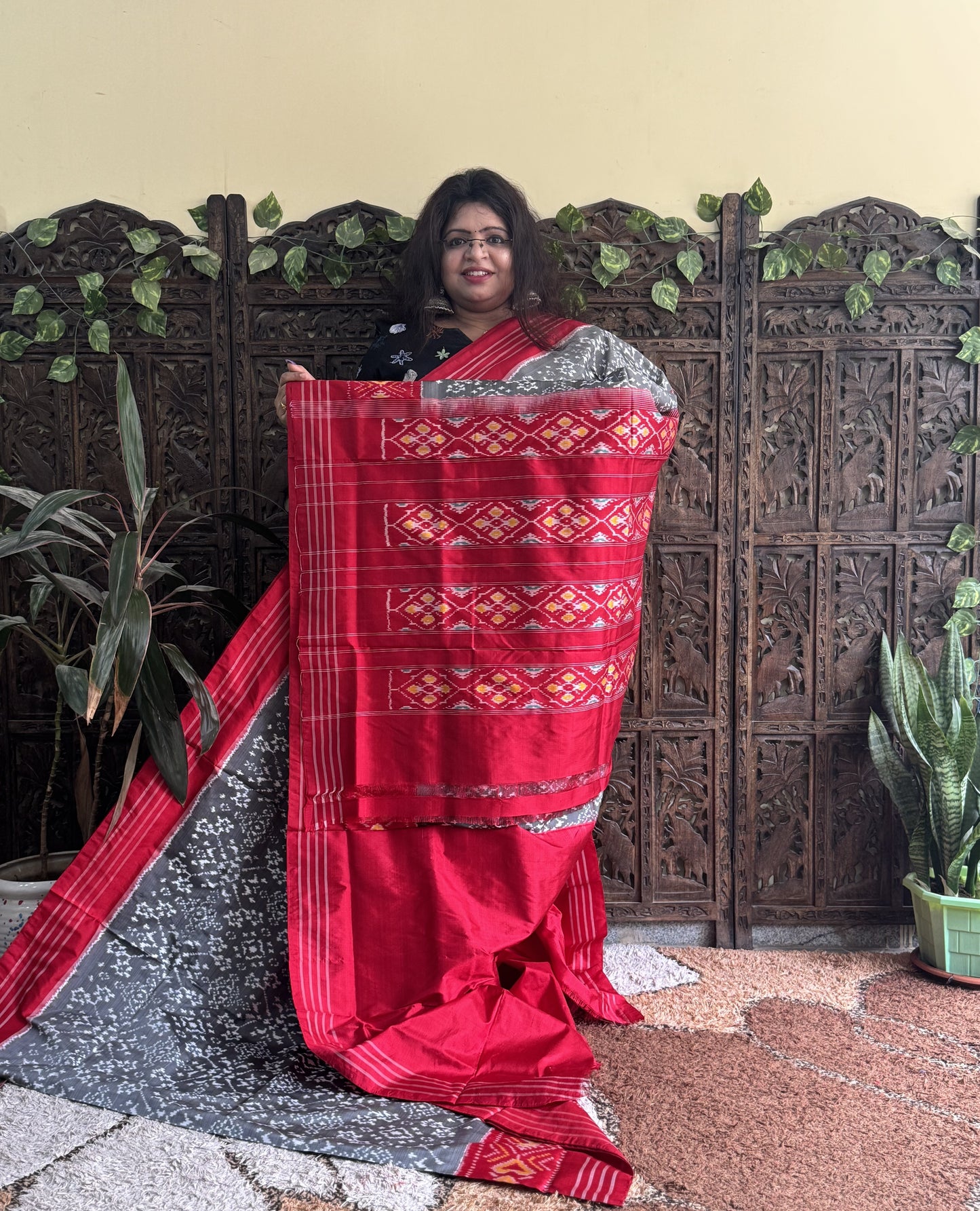 Ikkat Pattu Saree Gray colored complemented with a Red Patola border. - Sampradaya Designer Studio