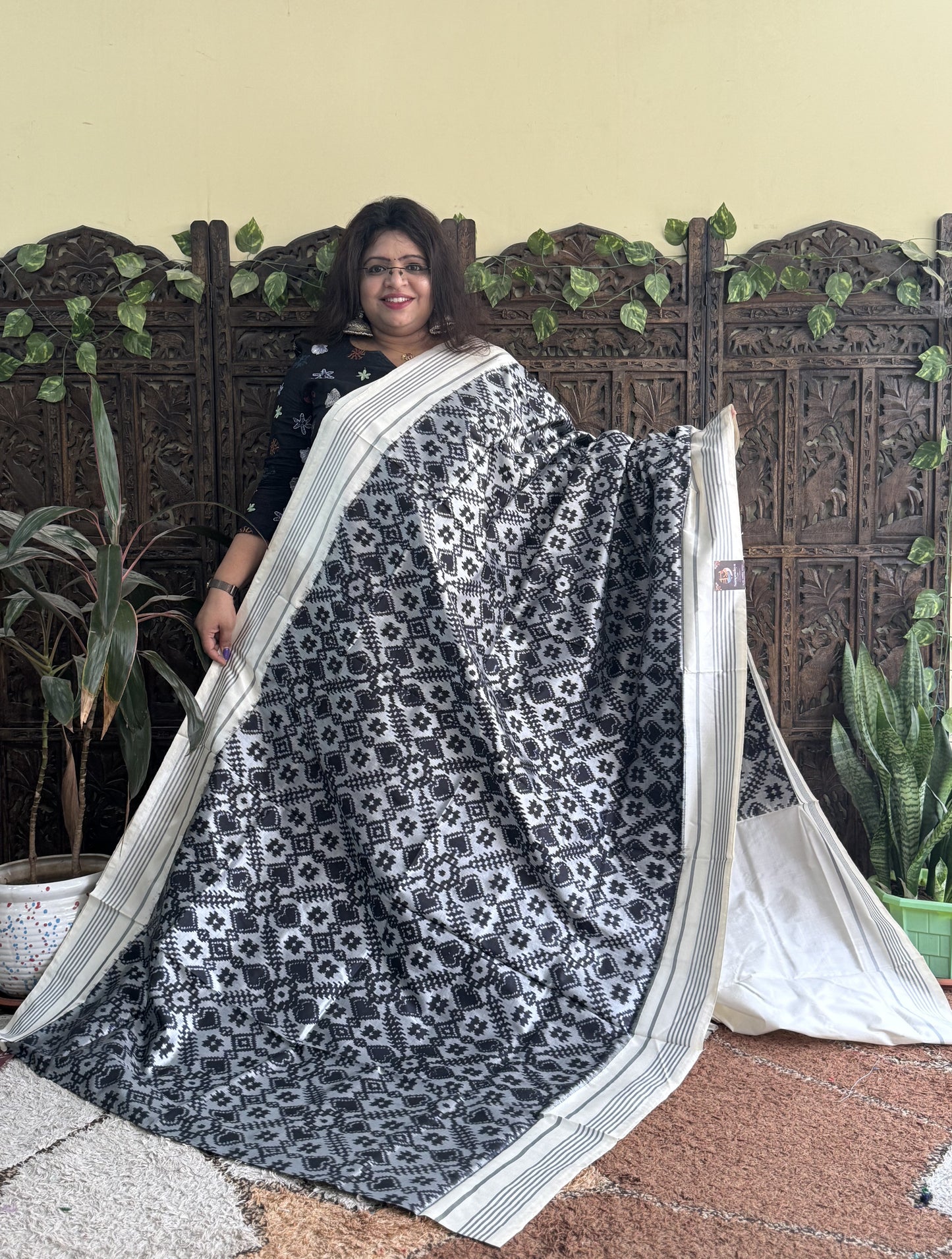 Ikkat Pattu Saree Gray colored complemented with a Patola border. - Sampradaya Designer Studio