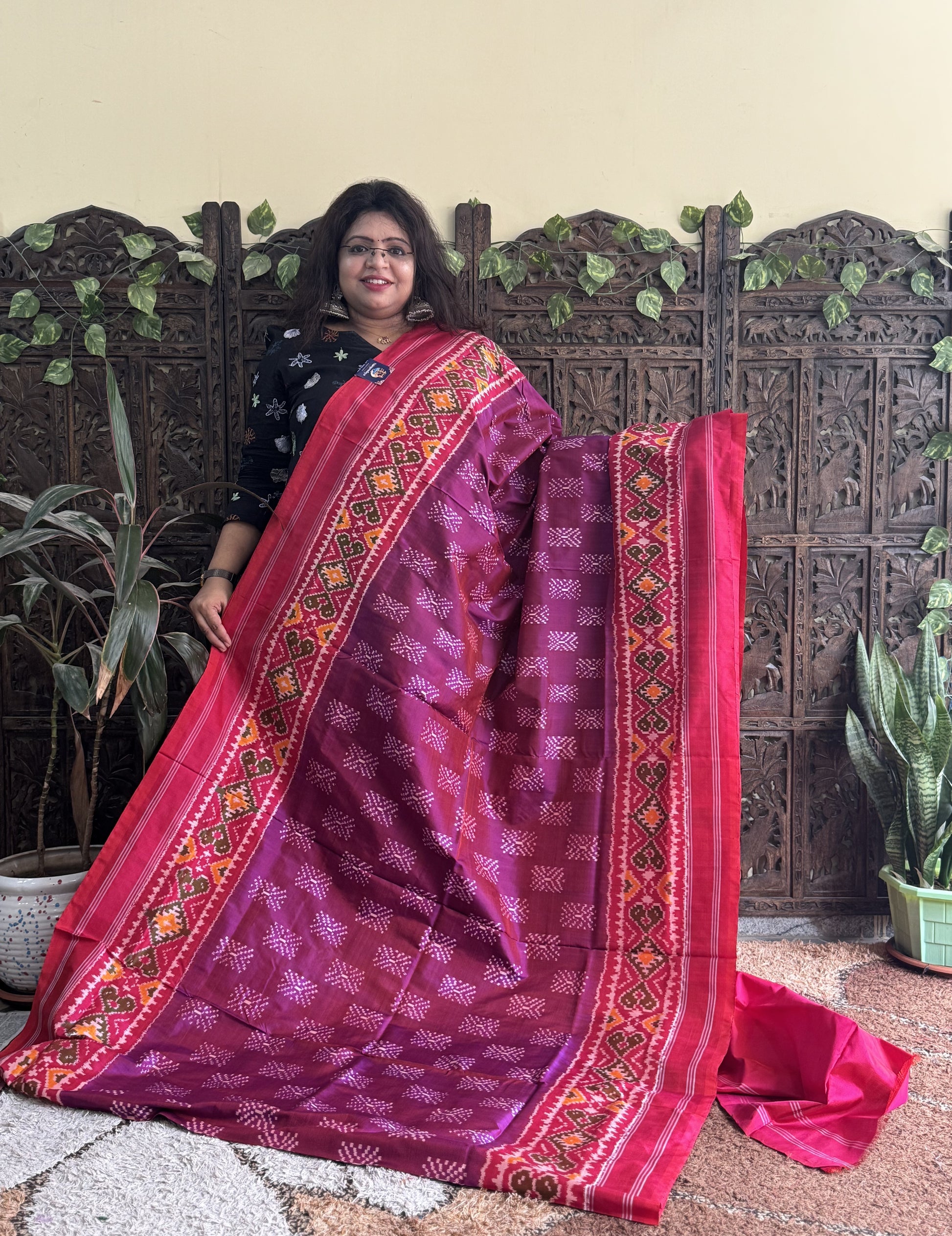 Ikkat Pattu Saree Wine colored complemented with a Patola border. - Sampradaya Designer Studio
