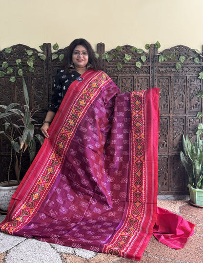 Ikkat Pattu Saree Wine colored complemented with a Patola border. - Sampradaya Designer Studio