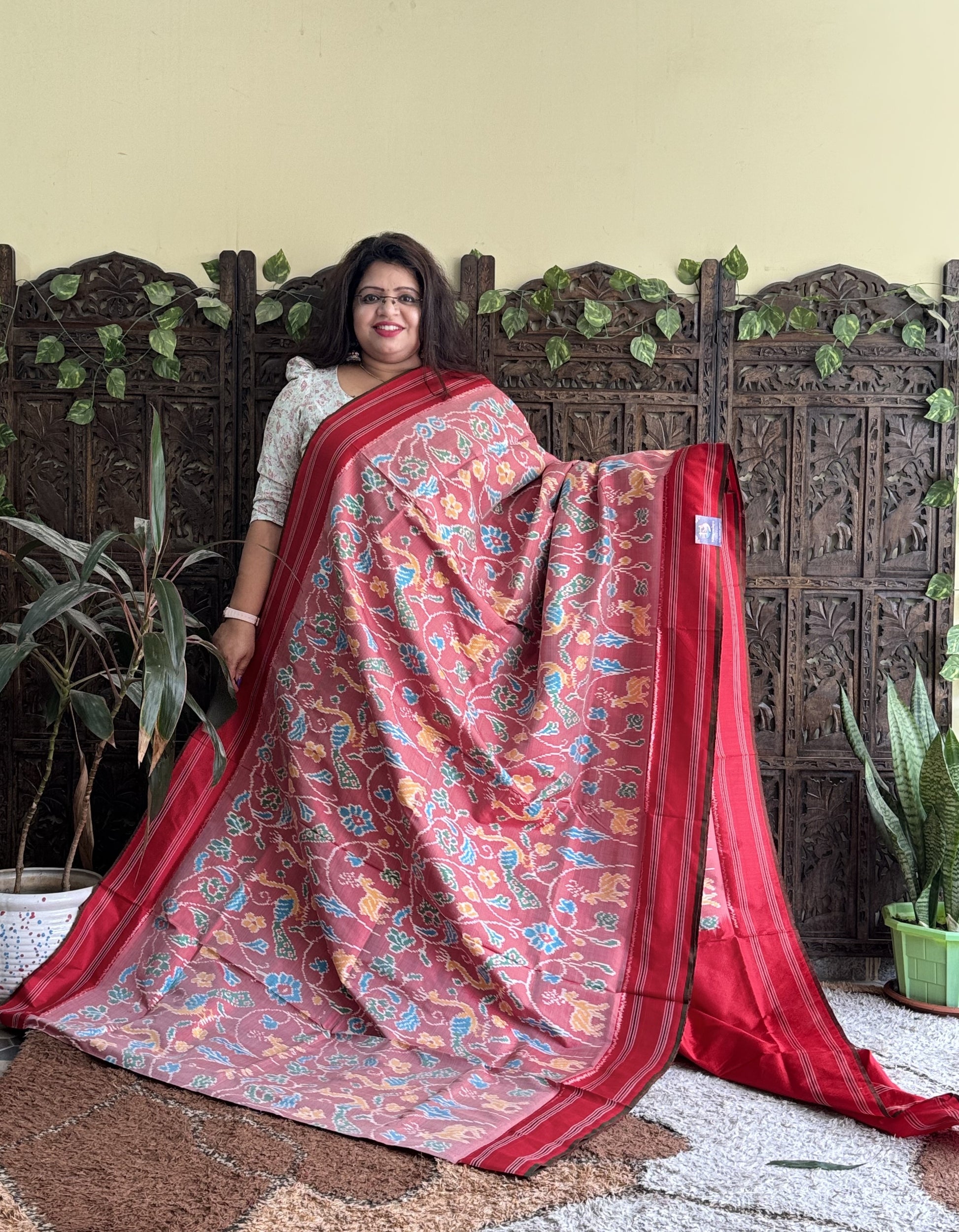 Ikkat Pattu Saree Onion Pink colored complemented with a Patola border. - Sampradaya Designer Studio