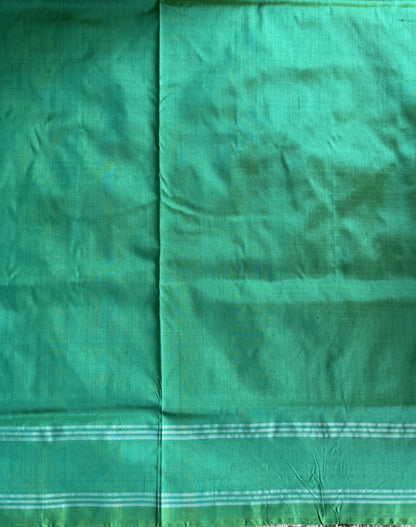 Ikkat Pattu Saree Parrot Green colored complemented with a Patola border. - Sampradaya Designer Studio