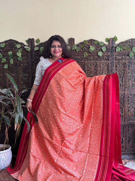 Ikkat Pattu Saree Light Orange colored complemented with a Patalo border. - Sampradaya Designer Studio