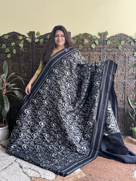Ikkat Pattu Saree Charcoal colored complemented with a Patola border. - Sampradaya Designer Studio