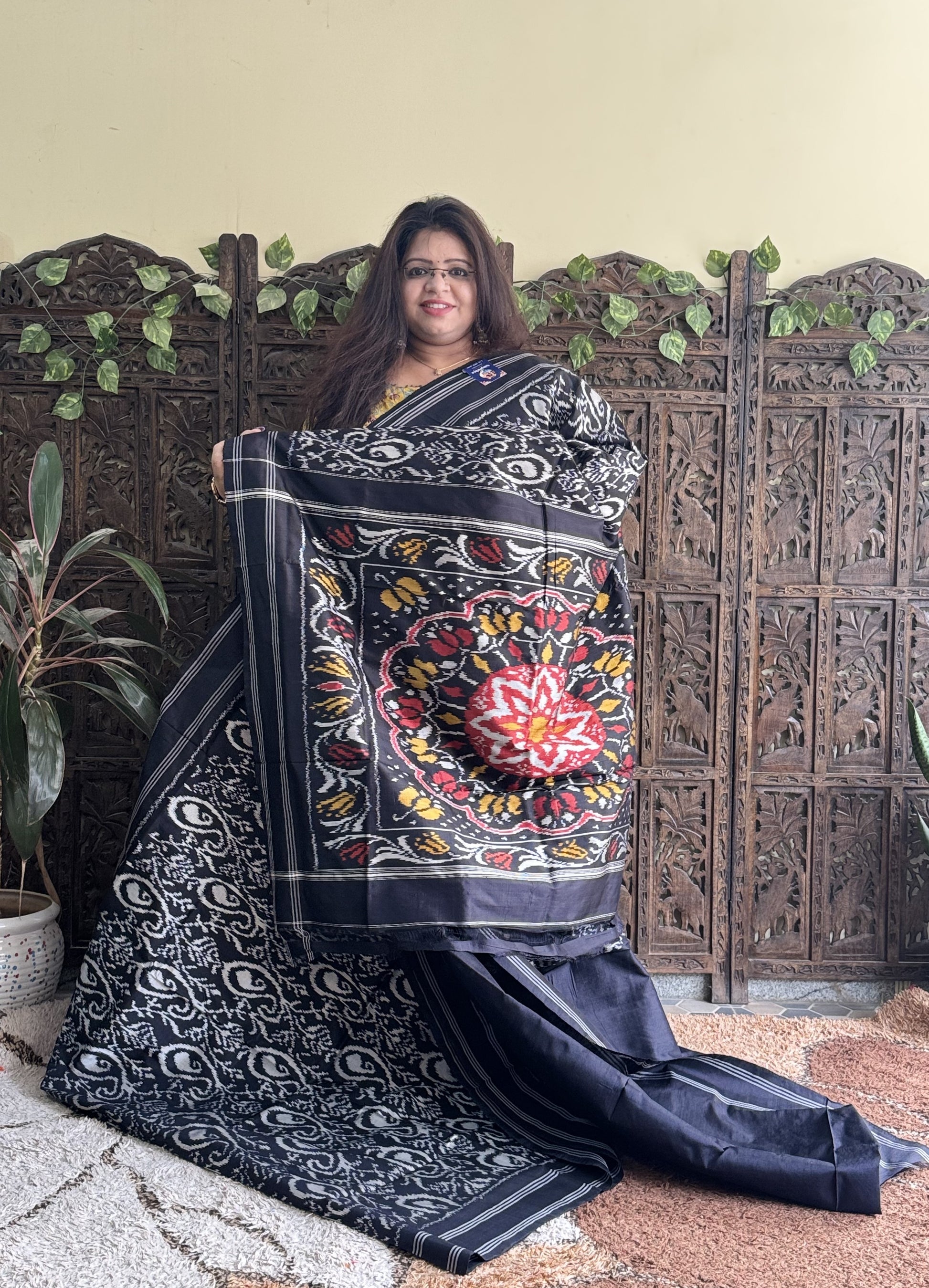 Ikkat Pattu Saree Charcoal colored complemented with a Patola border. - Sampradaya Designer Studio