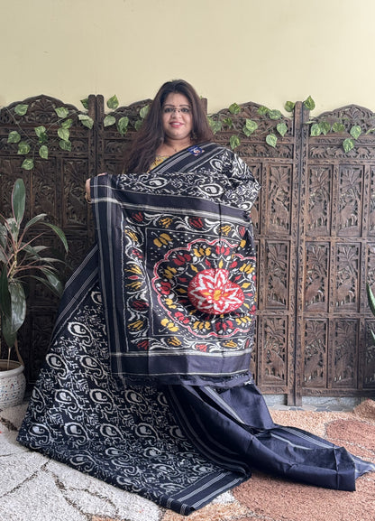 Ikkat Pattu Saree Charcoal colored complemented with a Patola border. - Sampradaya Designer Studio