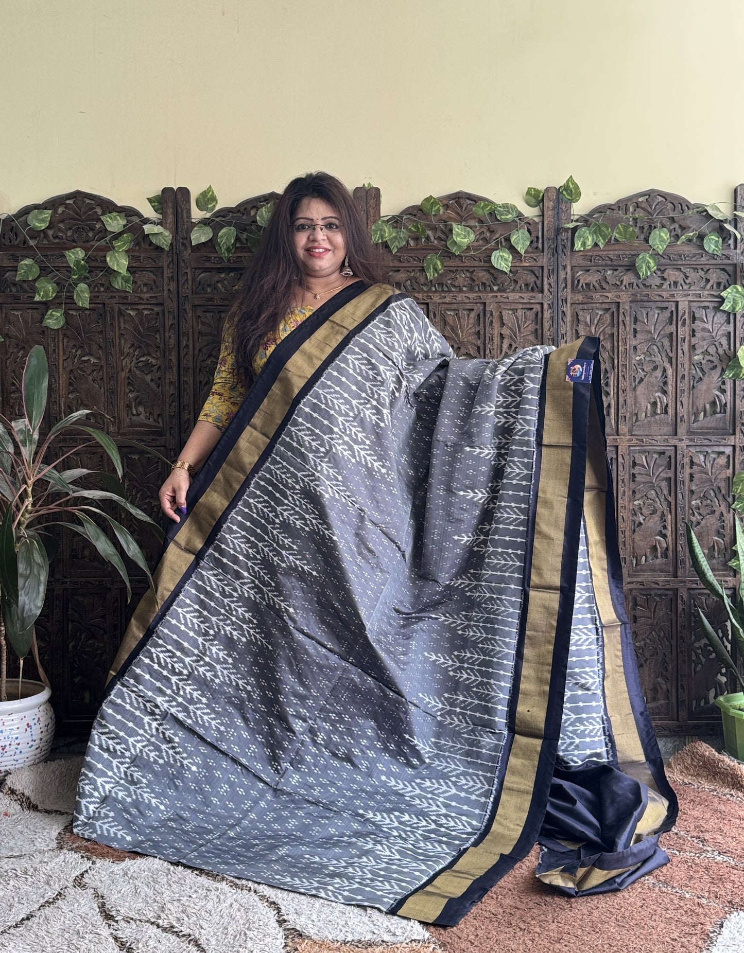 Ikkat Pattu Saree Gray colored complemented with a Black Zari border. - Sampradaya Designer Studio