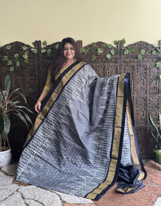 Ikkat Pattu Saree Gray colored complemented with a Black Zari border. - Sampradaya Designer Studio