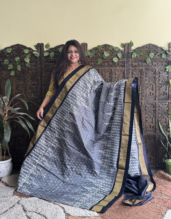Ikkat Pattu Saree Gray colored complemented with a Black Zari border. - Sampradaya Designer Studio