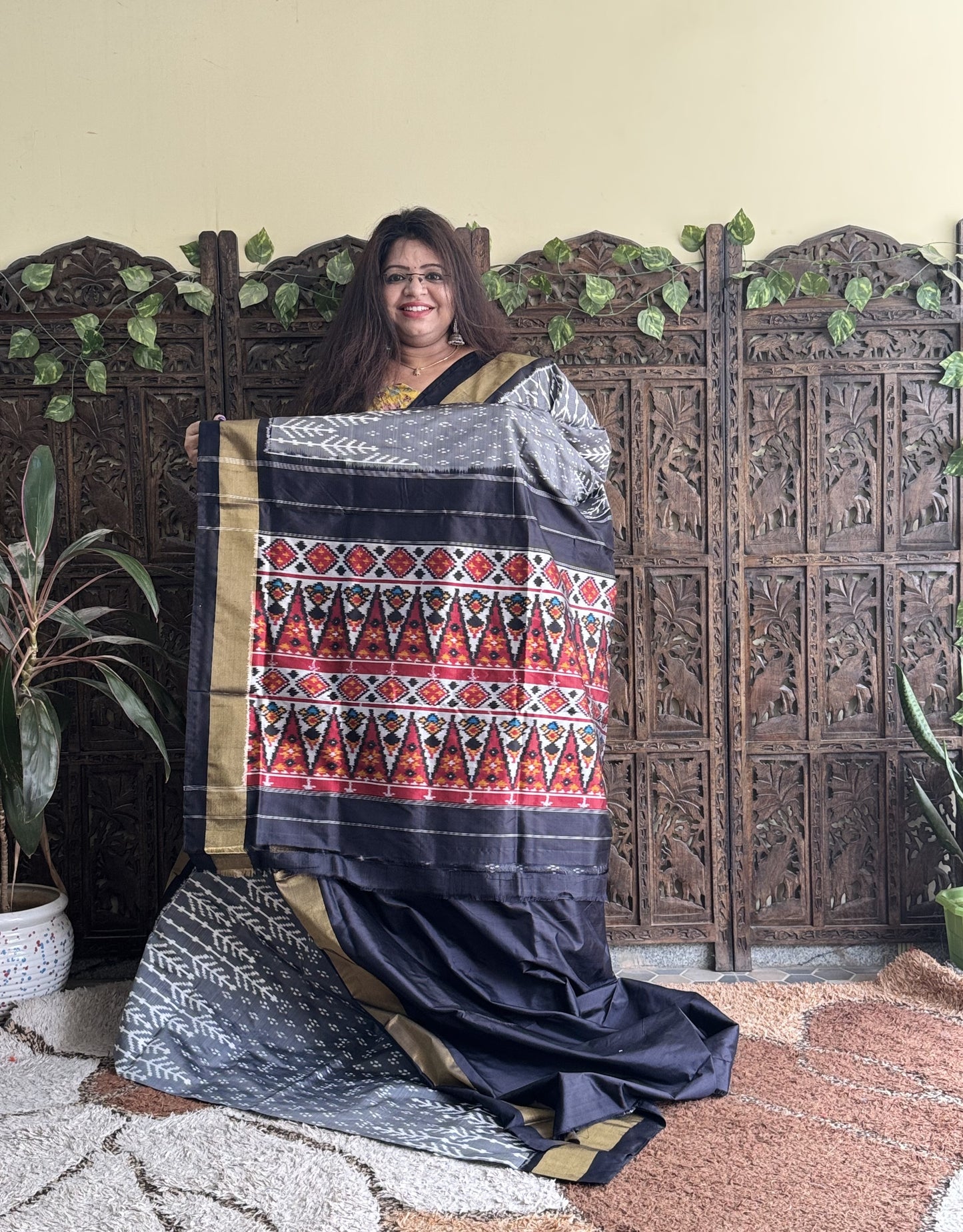 Ikkat Pattu Saree Gray colored complemented with a Black Zari border. - Sampradaya Designer Studio