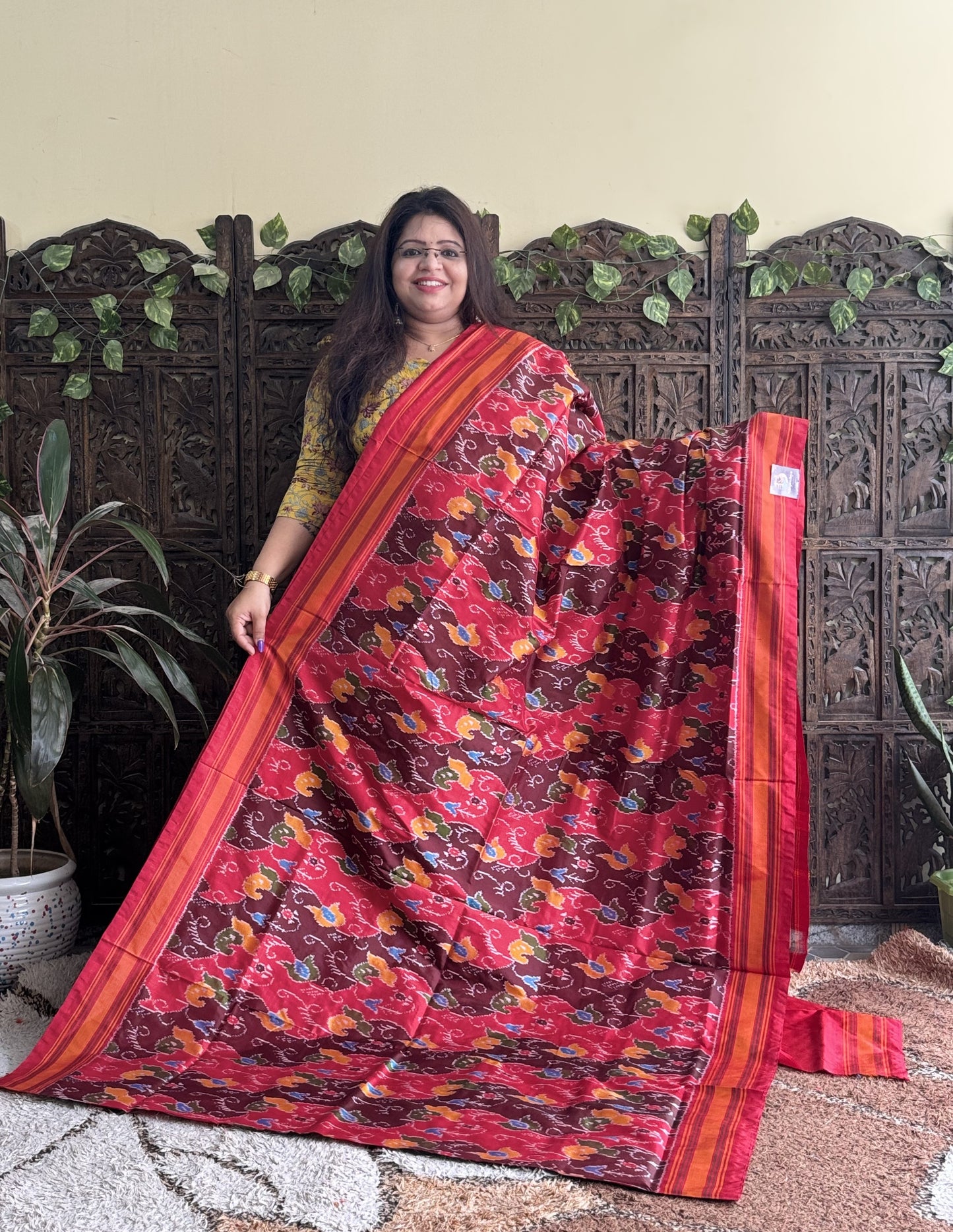 Ikkat Pattu Saree Red colored complemented with a Patola border. - Sampradaya Designer Studio