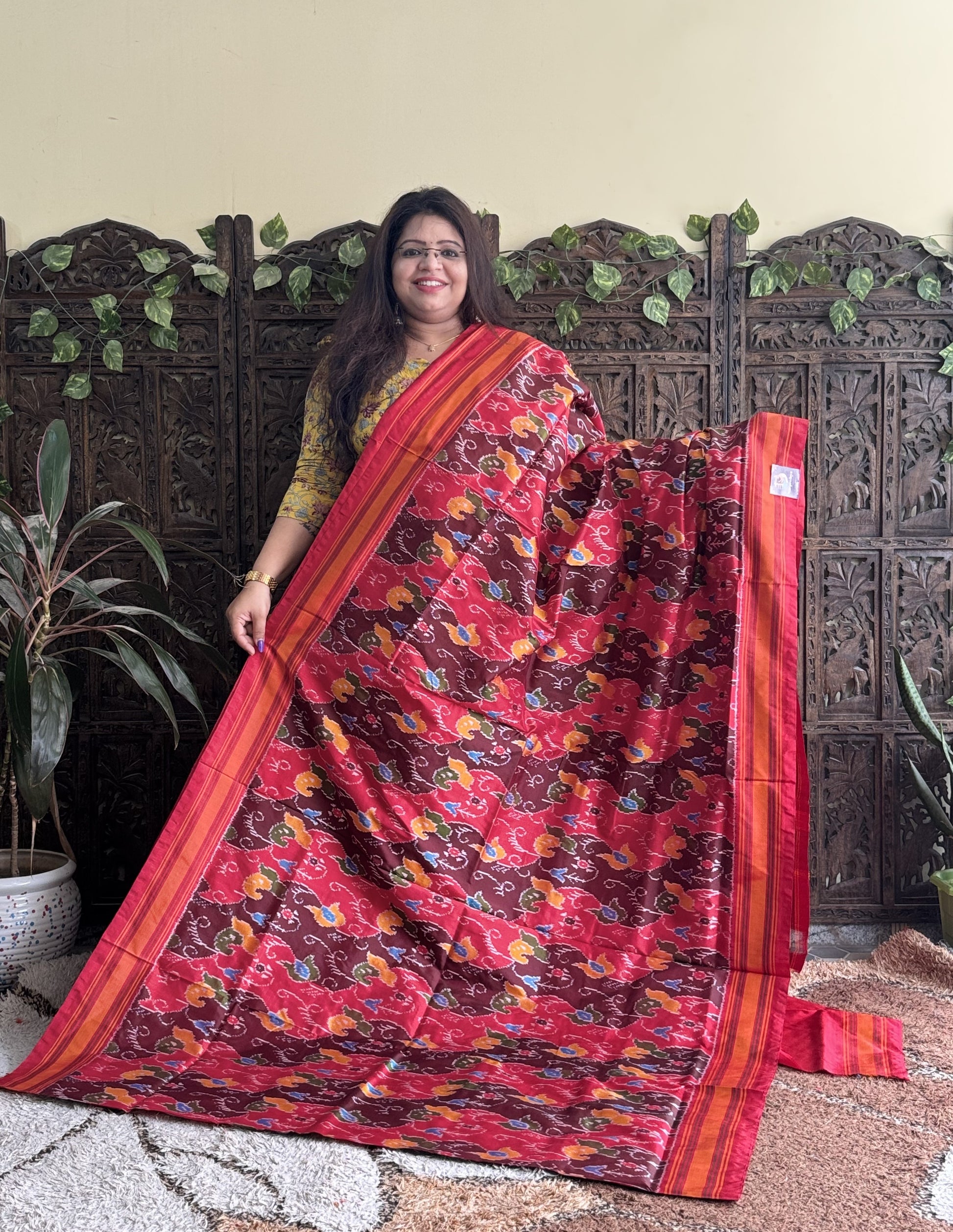 Ikkat Pattu Saree Red colored complemented with a Patola border. - Sampradaya Designer Studio