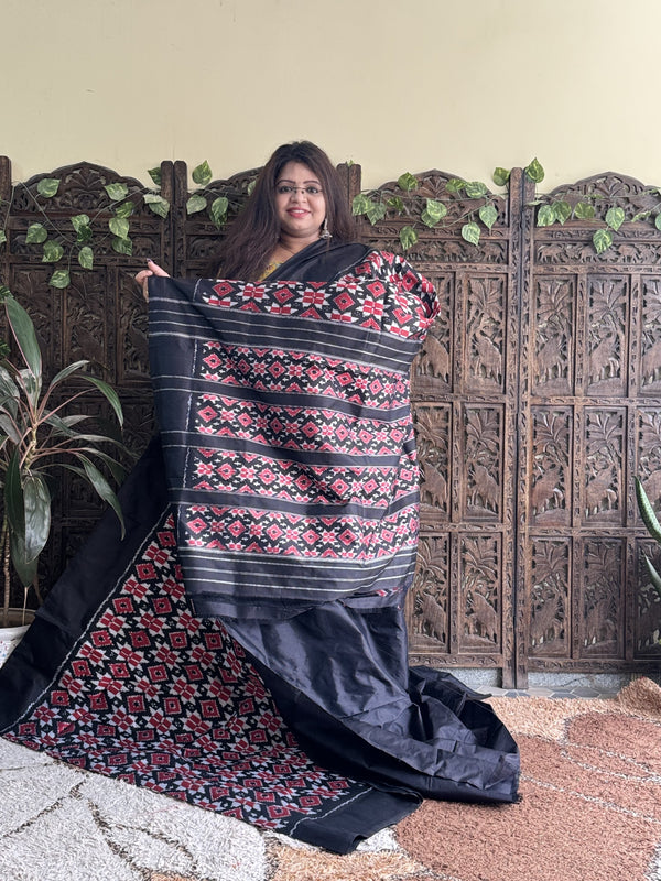 Ikkat Pattu Saree Black colored complemented with a Plain border. - Sampradaya Designer Studio